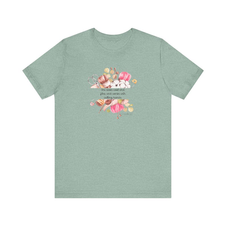 Proverbs 31:13 t shirt with images of pink, white and green knitting needles, crochet hooks, yarn and foliage.