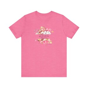 Proverbs 31:13 t shirt with images of pink, white and green knitting needles, crochet hooks, yarn and foliage.