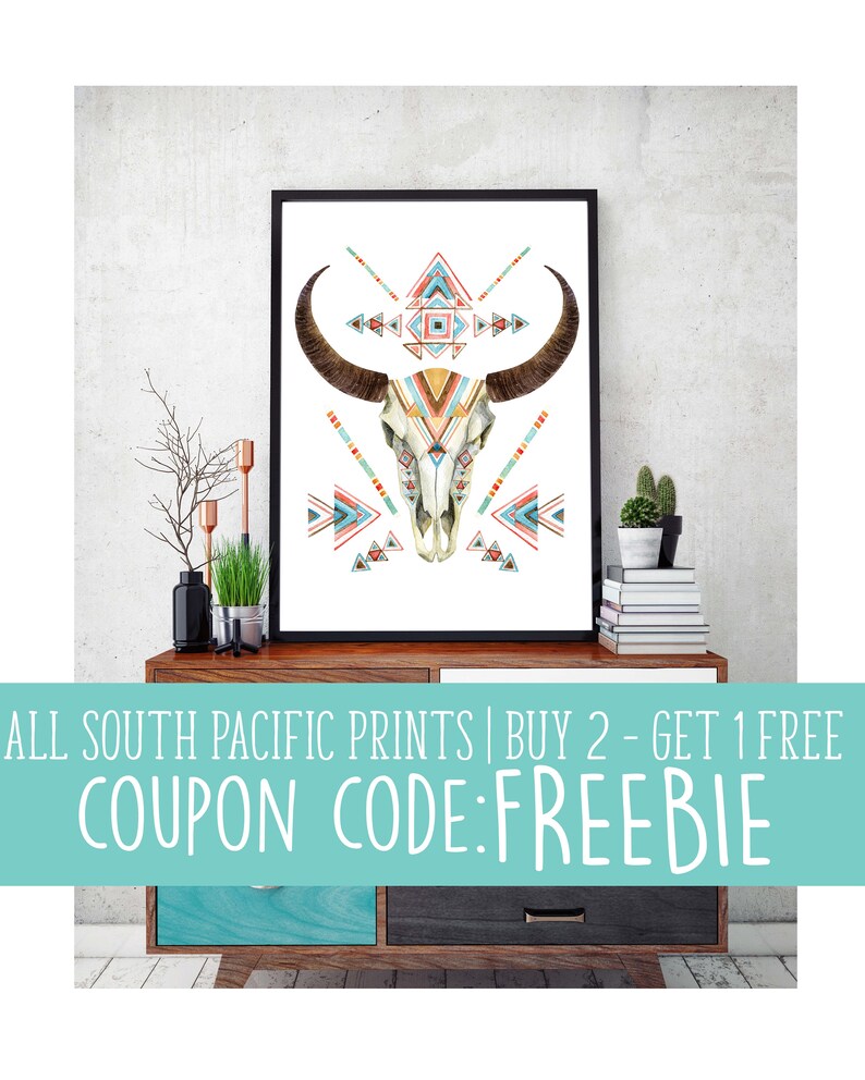 May include: Framed art print featuring a watercolor illustration of a bull skull with geometric patterns in teal, orange, and red. The artwork is displayed on a wooden cabinet. Text on the image reads: ALL SOUTH PACIFIC PRINTS | BUY 2 - GET 1 FREE COUPON CODE: FREEBIE.