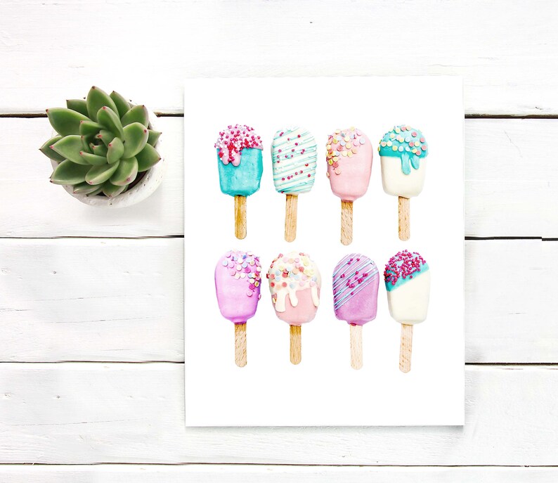 May include: Watercolor painting of nine colorful ice cream bars on wooden sticks. The ice cream bars are in various pastel colors, including pink, blue, and white, and are decorated with sprinkles and drizzles. The artwork is on a white background.