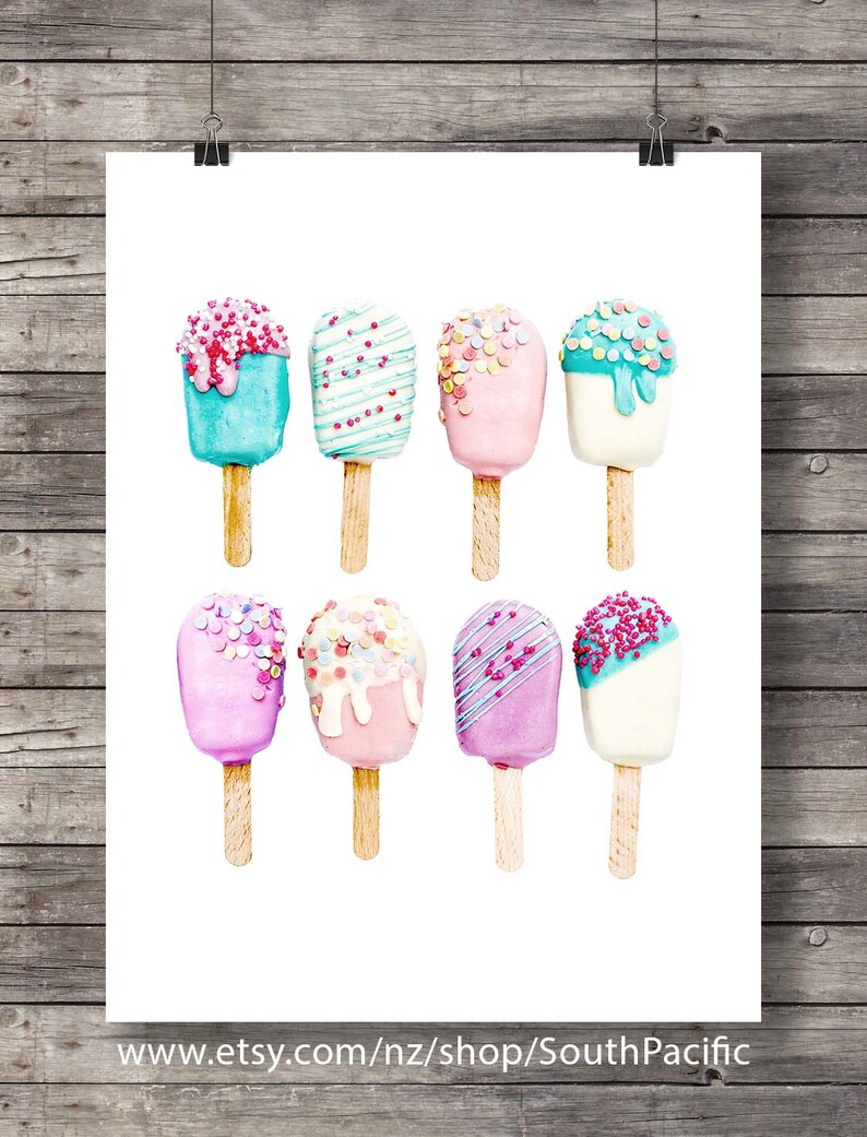 May include: Watercolor print featuring eight colorful popsicle illustrations. Each popsicle has a unique design with sprinkles and drizzles in shades of pink, blue, and white. The popsicles are on wooden sticks, set against a white background.