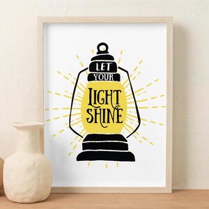 May include: A black and yellow print with a lantern and the text "Let your light shine".