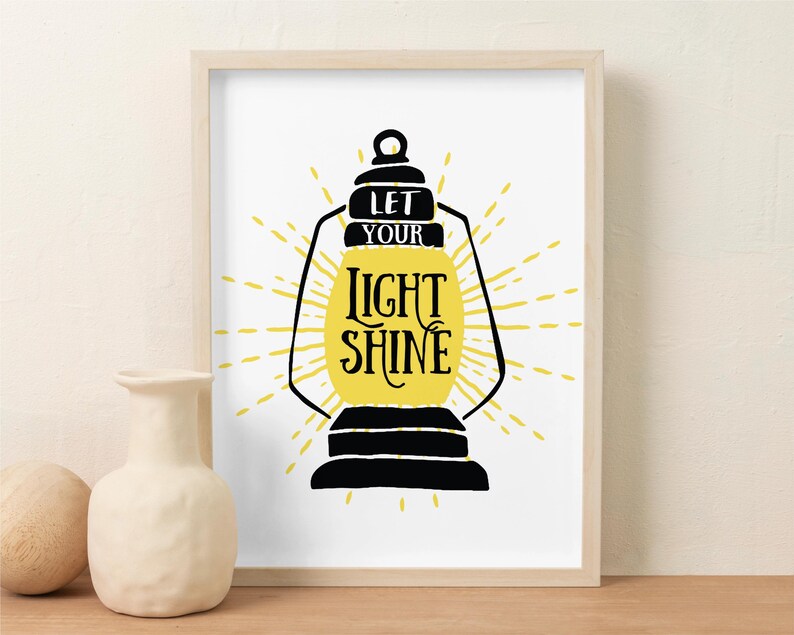 May include: A black and yellow print with a lantern and the text "Let your light shine".