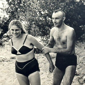 1960s Vintage beach photo Woman in bathing suit smiling woman guy holds hands Loving couple Snapshot