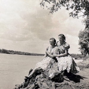 Vintage female portrait 1958 Two Young Pretty Women Students Romantic beauties on bank of big river Old Snapshot photography