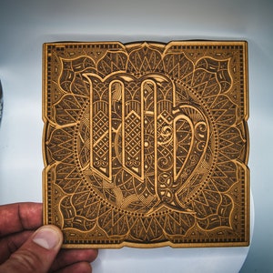 May include: A wooden plaque with an intricate design featuring the astrological symbol for Virgo. The design is laser cut and features a detailed pattern of geometric shapes and lines.
