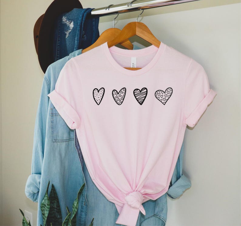 3 whimsical hand drawn hearts on a t-shirt.