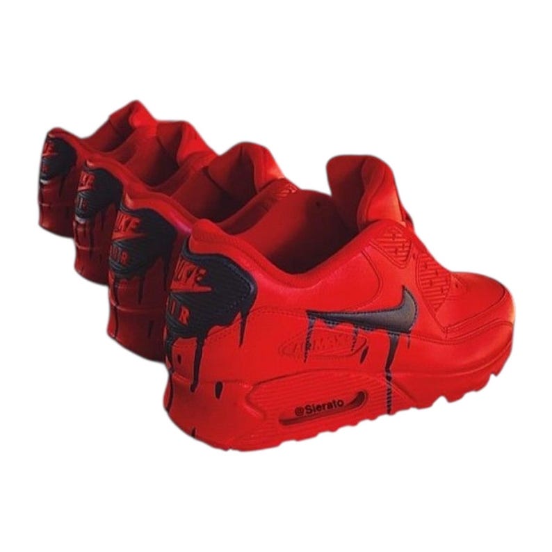 May include: Red athletic shoes with black accents and a dripping paint design. The shoes have a Nike swoosh and the text "AIR MAX" on the side. The sole has the text "@Sierato".