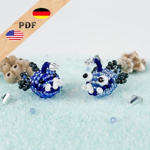 May include: Two handcrafted beaded anglerfish figures made from small blue, white, and black glass beads. Each fish features a prominent lure extending from the head, large white eyes with black pupils, and small fins made of dark beads.