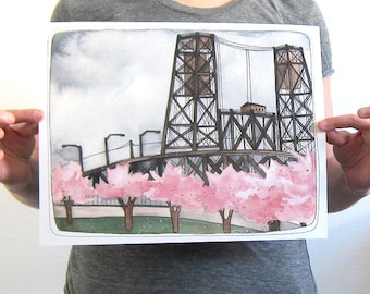 May include: Watercolor painting of a bridge with two towers and a small building in the middle. The bridge is surrounded by pink cherry blossoms.