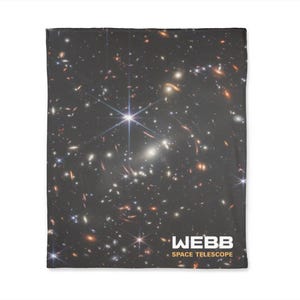 May include: A black and white image of a galaxy with a bright star in the center. The image is labeled "WEBB SPACE TELESCOPE".