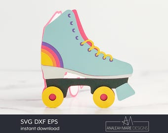 May include: A light blue roller skate with rainbow accents and yellow wheels. The skate is a digital cut file for crafting.