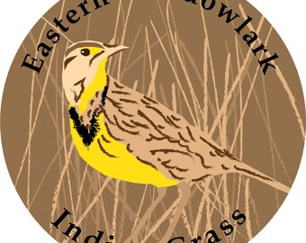 Può includere: Un cerchio marrone con il testo "Eastern Meadowlark" e "Indian Grass" attorno al bordo. Un uccello giallo e marrone è al centro del cerchio.
