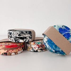 Set of 4 round coasters made of 100% recycled plastic. Handmade sustainable gift.