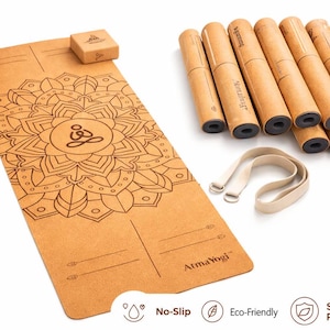 May include: A tan cork yoga mat featuring a black mandala print and the AtmaYogi logo, accompanied by two matching cork blocks, seven rolled yoga mats, and a beige carrying strap. The mat includes alignment lines and a central lotus figure.