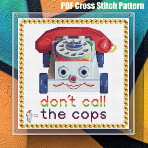 May include: Cross stitch pattern featuring a red toy phone with a white face and the text "don't call the cops".
