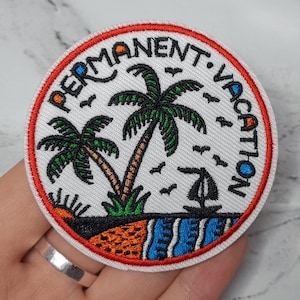 May include: Circular embroidered patch with the text "PERMANENT VACATION". The design includes palm trees, a sailboat, and a beach scene in green, brown, blue, orange, and black, with a red border. The patch is round.
