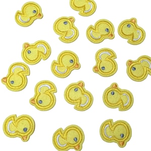 May include: A set of 15 yellow felt iron-on patches featuring a cartoon chick design. Each patch is approximately 1 inch in size.