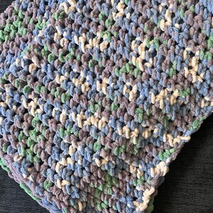 May include: A soft, crocheted blanket with a striped pattern in shades of blue, green, white, and gray.
