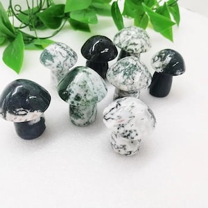 May include: A collection of eight green and white agate mushroom shaped stones. The stones are polished and have a natural, organic look.