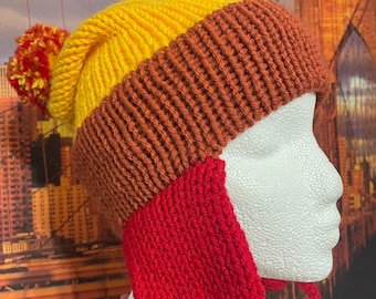 May include: A knitted hat with a yellow, brown, and red color scheme. The hat has a pom-pom on top and ear flaps.