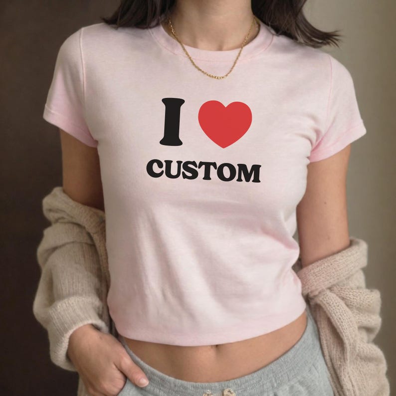 May include: A pink t-shirt with a black graphic that says "I love custom" with a red heart.