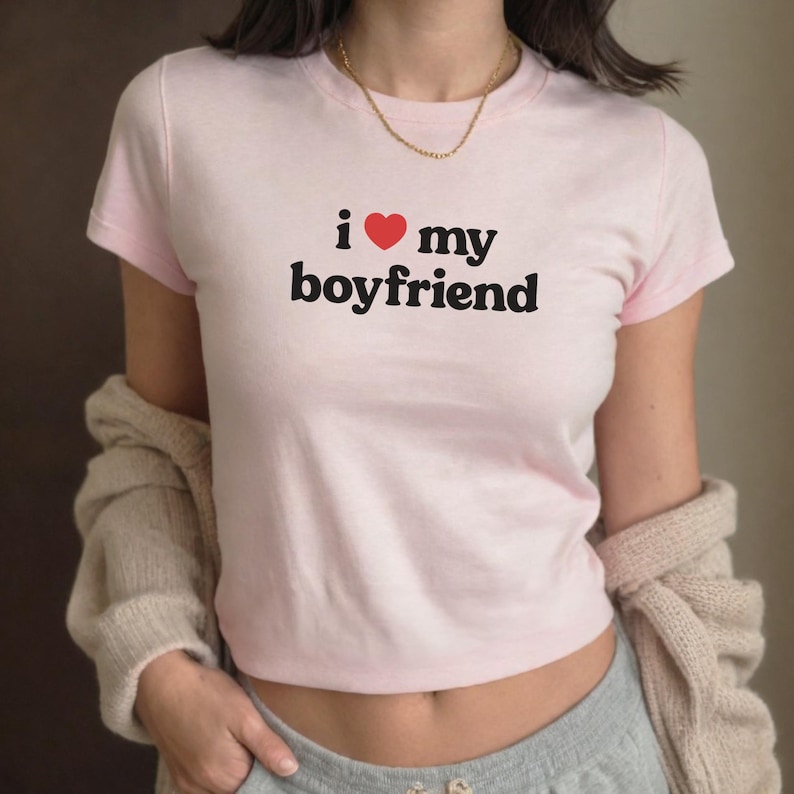May include: A pink t-shirt with the text "i &hearts; my boyfriend" printed on the front.