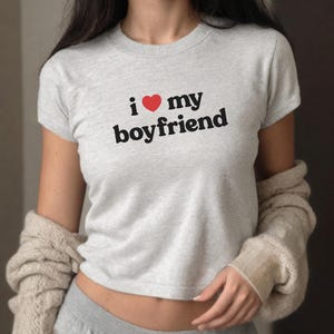 May include: A gray cropped t-shirt with the text "i &hearts; my boyfriend" printed on the front.