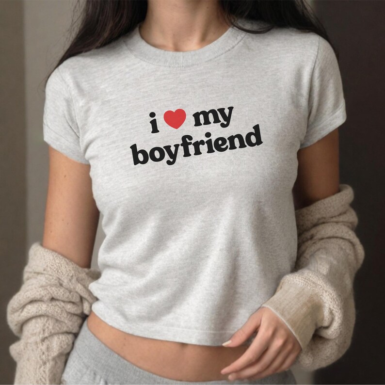 May include: A gray cropped t-shirt with the text "i &hearts; my boyfriend" printed on the front.