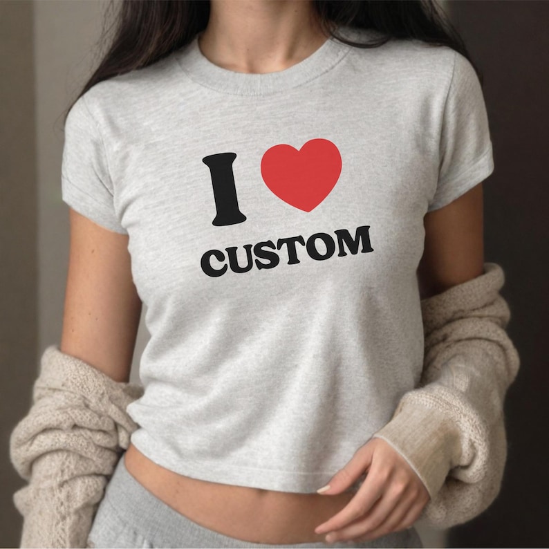May include: A gray cropped t-shirt with a black graphic that says "I love CUSTOM" with a red heart.
