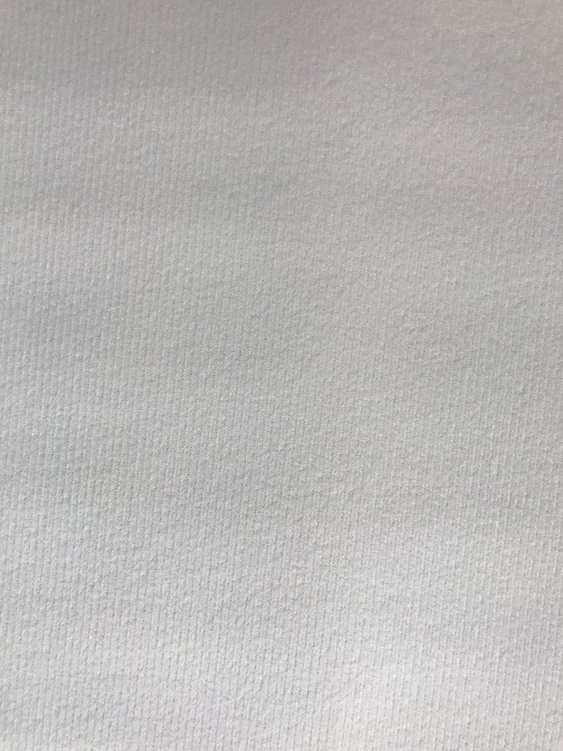 May include: A close-up of a white textured surface.