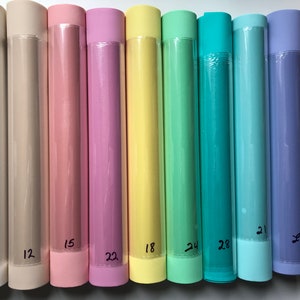 May include: Ten rolls of pastel colored wrapping paper, each with a number written on the bottom. The colors are beige, light pink, pink, yellow, light green, teal, light blue, purple, and red.