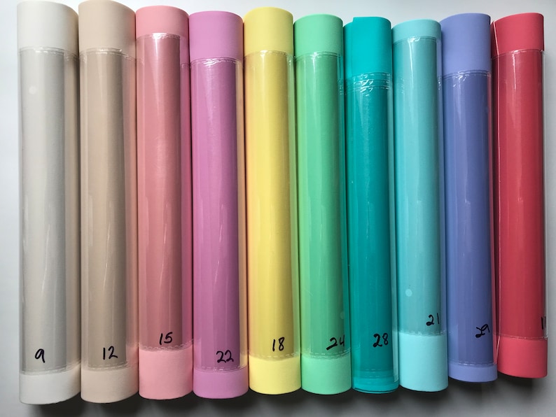 May include: Ten rolls of pastel colored wrapping paper, each with a number written on the bottom. The colors are beige, light pink, pink, yellow, light green, teal, light blue, purple, and red.