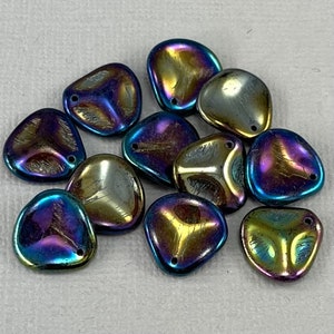 May include: A group of iridescent glass beads in shades of blue, purple, and gold. The beads are shaped like teardrops and have a smooth, shiny finish.