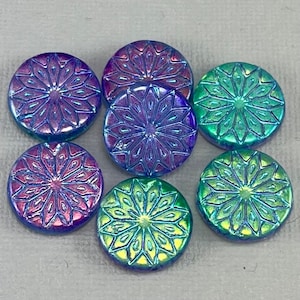 May include: Six iridescent glass buttons with a starburst design. The buttons are in shades of blue, green, and purple.