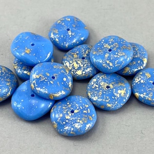 May include: A collection of light blue glass beads with gold flecks. The beads are round and have a hole in the centre. They are ideal for jewellery making or other crafts.