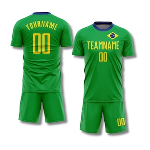 May include: Green soccer uniform set with a blue collar and yellow accents. The jersey features the text "YOURNAME" and the number "00" on the back, and "TEAMNAME" and the number "00" on the front, along with a Brazilian flag emblem.