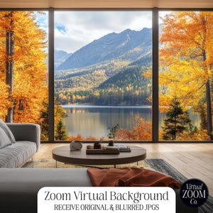 May include: A gray sectional sofa sits in front of a large window with a view of a lake and mountains. The mountains are covered in trees, some of which are yellow and orange. The window is framed by a wooden wall. The text "Zoom Virtual Background" and "RECEIVE ORIGINAL & BLURRED JPGS" is visible at the bottom of the image.