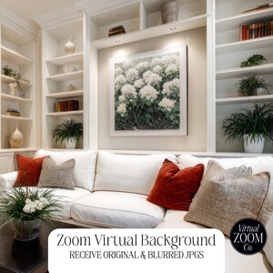 May include: A living room scene featuring a white sofa with decorative pillows in shades of red and tan. A framed floral print hangs above the sofa, and built-in white shelves are filled with books and plants. A dark coffee table holds floral arrangements.