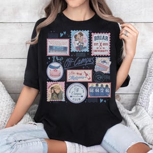 May include: Black t-shirt featuring a collage of stamp-like designs. The stamps include images of a couple, a cake, a keyboard, and the text "Off Campus." Other text includes "Briar University" and "Malone's."