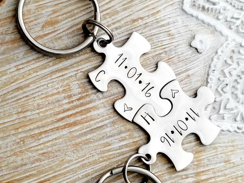 Puzzle keychains that fit together with a date, anniversary date, special day.  One initial on each keychain and a heart