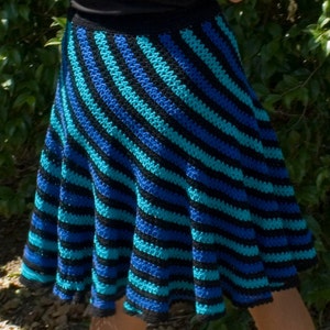 May include: A blue and black striped crochet skirt with a flared silhouette.
