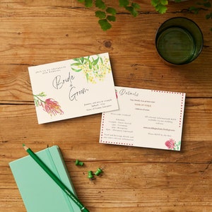 May include: A wedding invitation with floral designs. The front of the card says "Bride & Groom" and the back has details about the wedding, including the date, time, and location.