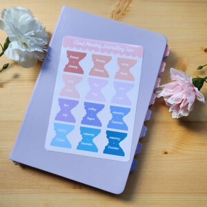 May include: A sheet of colorful monthly journaling tabs with a cloud shape and scalloped edges. The tabs are labeled with the months of the year, from January to December. The text "Cloud Monthly Journalling Tabs" is printed at the top of the sheet.