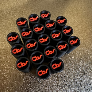 May include: A collection of twenty black and red silicone pipe tips with the letters "Cbr" printed in red on each tip.