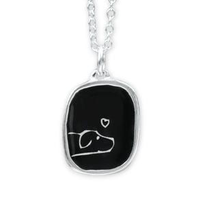 May include: A silver necklace with a black enamel pendant featuring a simple line drawing of a dog with a heart above it.