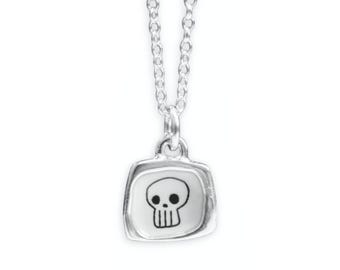 May include: A silver necklace with a square pendant featuring a black and white skull illustration.