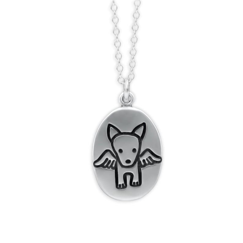 May include: Silver pendant necklace featuring an oval pendant with a black and white cartoon dog with wings. The dog has a simple design with a small body, large ears, and outstretched wings. The necklace chain is a delicate silver link.