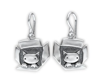 May include: Silver dangle earrings featuring a cat peeking out of a box. The cat is silver with a black face and paws. The box is silver with a black interior.
