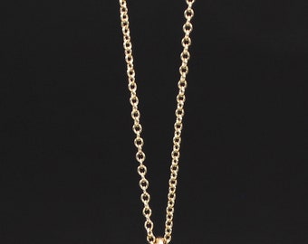 May include: A gold chain necklace with a simple, delicate design. The chain is made of small, round links.